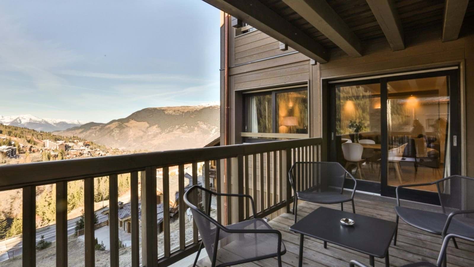Covered balcony with mountain valley views and seating for four