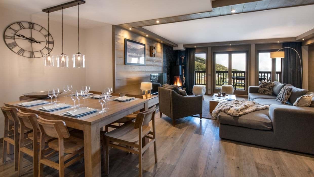 Open living area with wood-burning stove and mountain view balcony