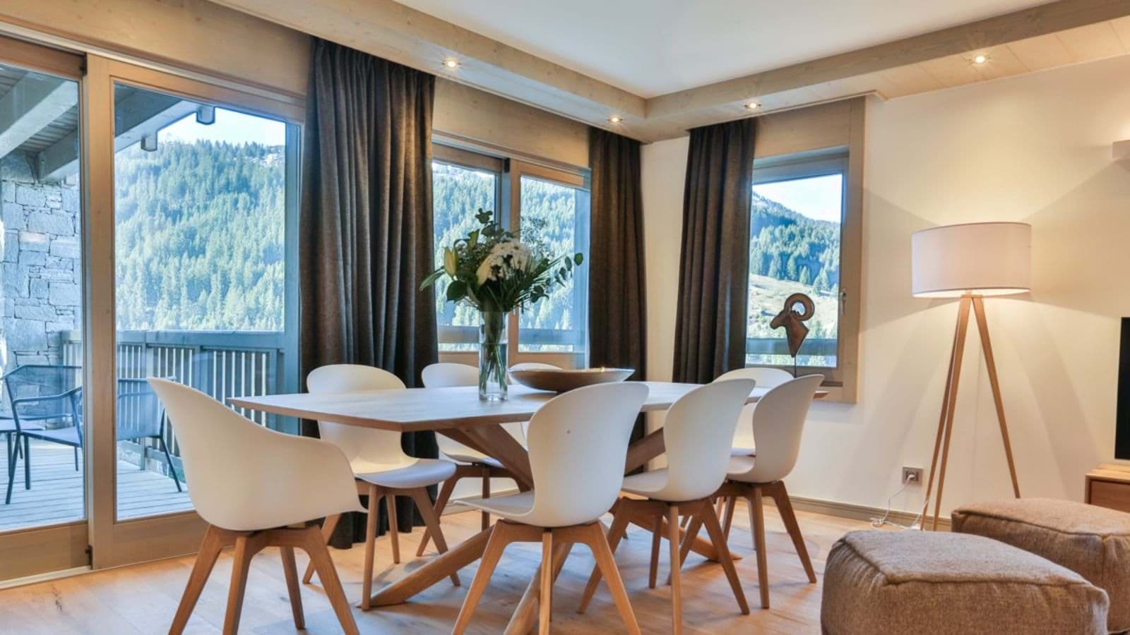 Dining area seats 6 with mountain views and balcony access