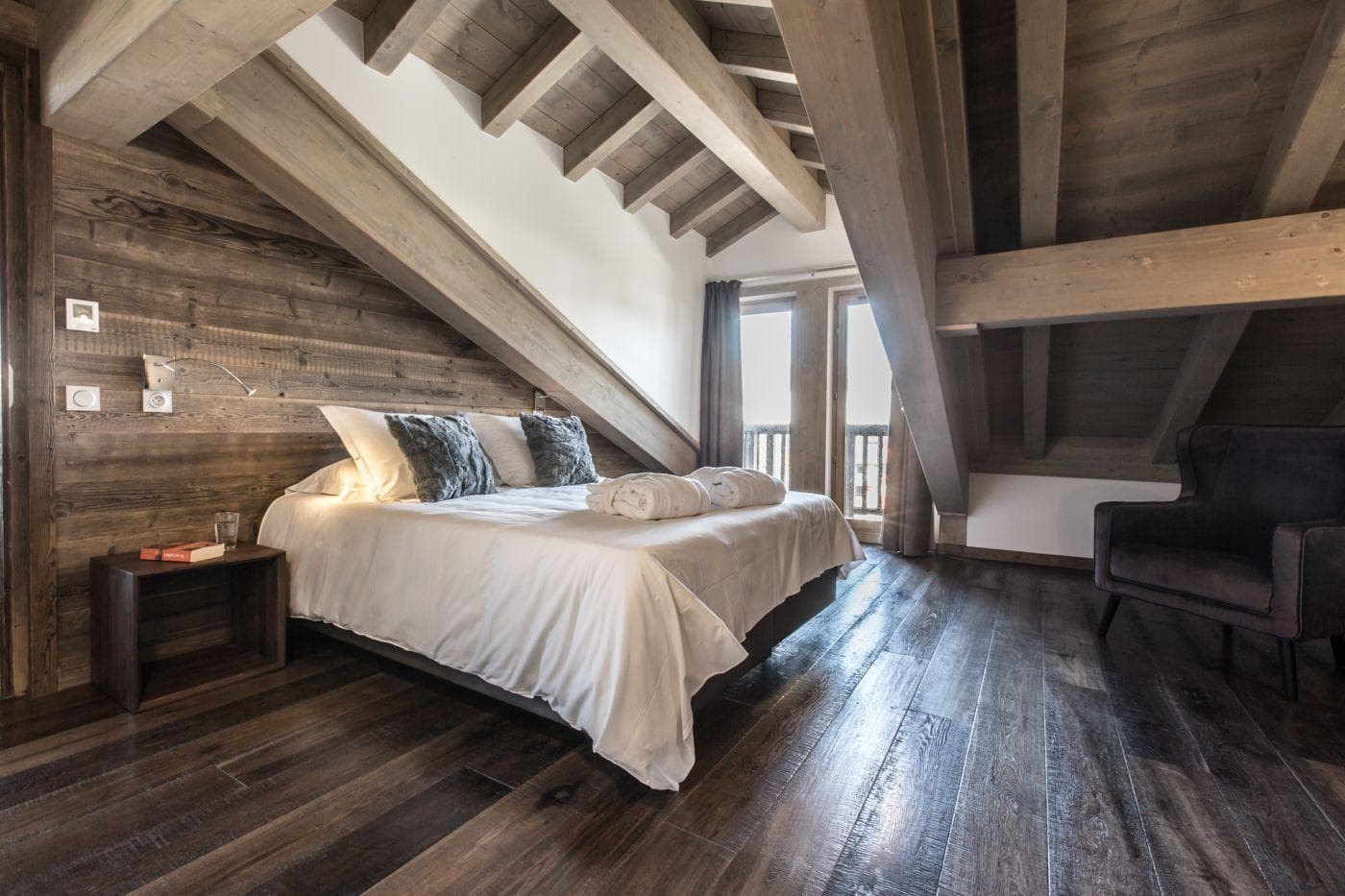 Attic bedroom with queen bed and exposed timber beams