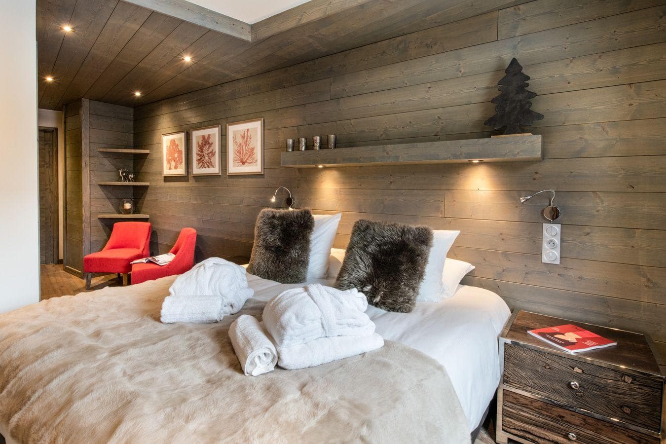 Guest bedroom with king bed and reading lights; reclaimed wood walls