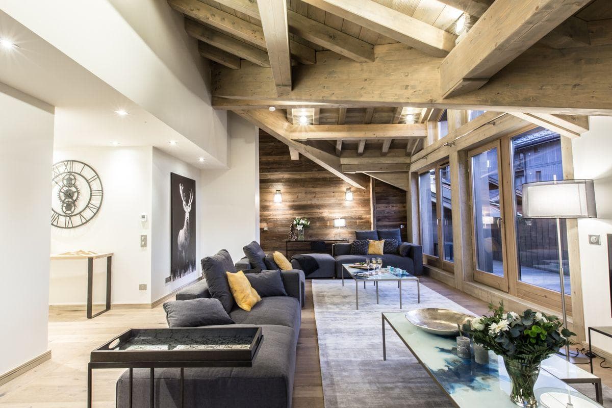 Living area with vaulted timber ceilings and floor-to-ceiling windows