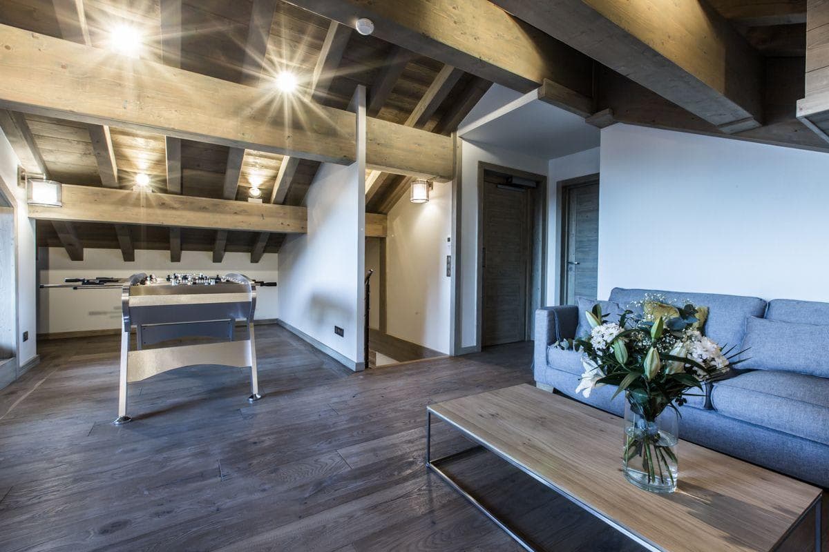 Upper floor lounge with foosball table and exposed timber beams