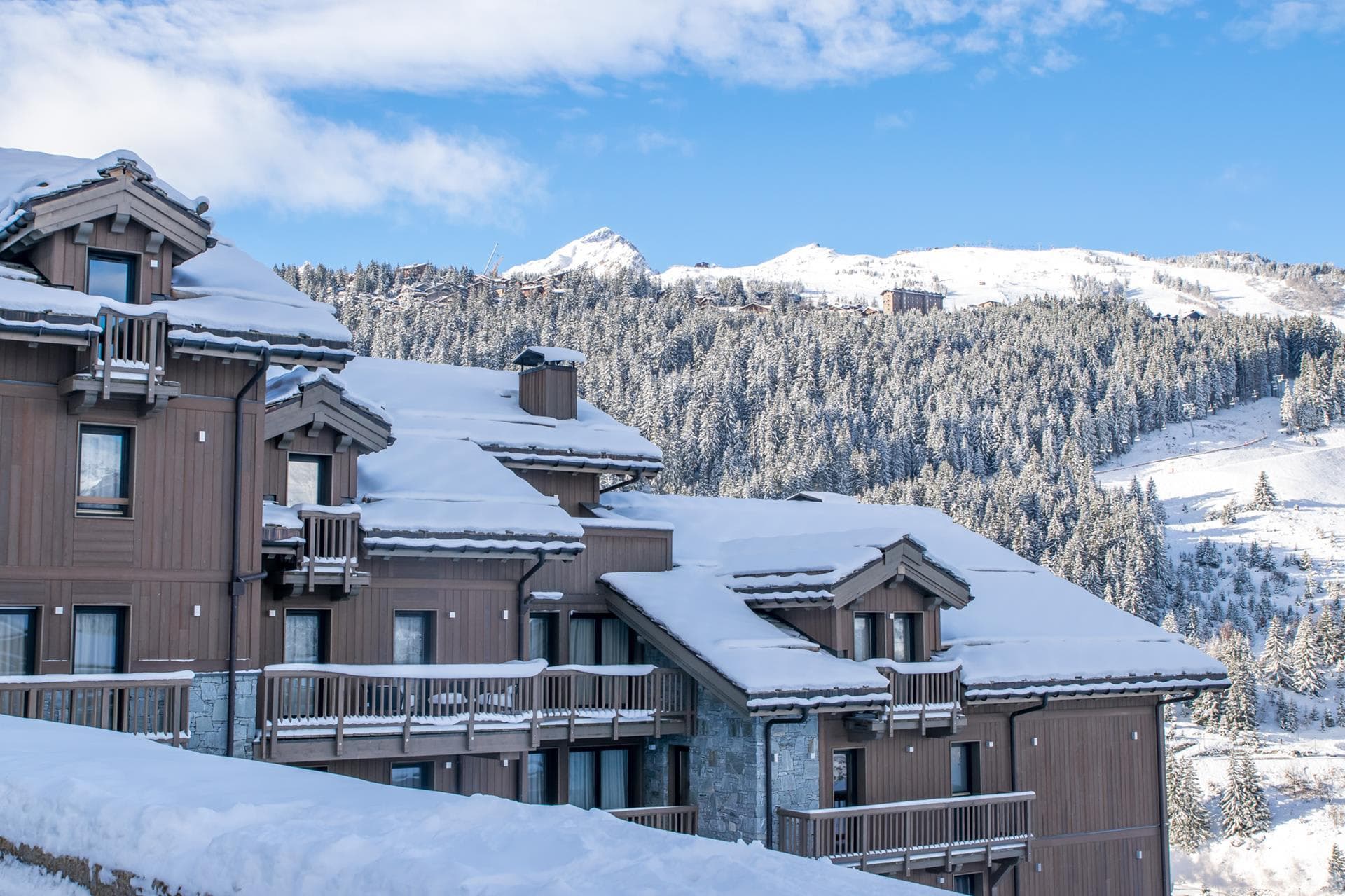 Chalet exterior with private balconies and ski slope views