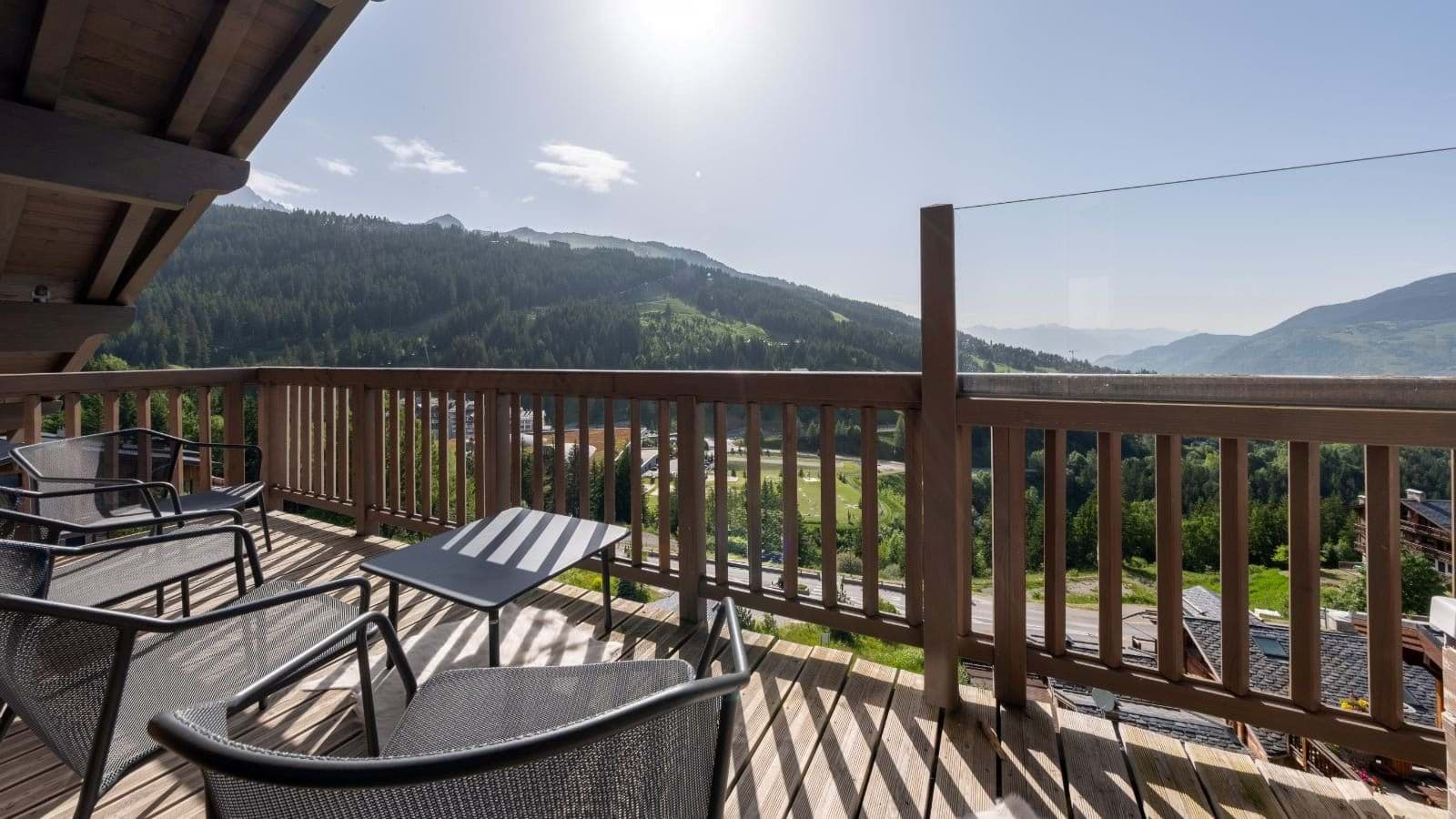 Private balcony with lounge seating and alpine valley views