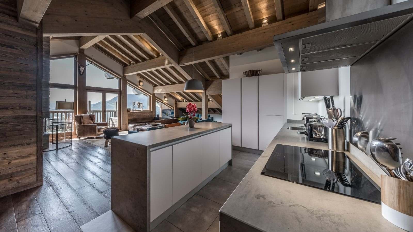 Open-plan kitchen with induction cooktop and mountain views