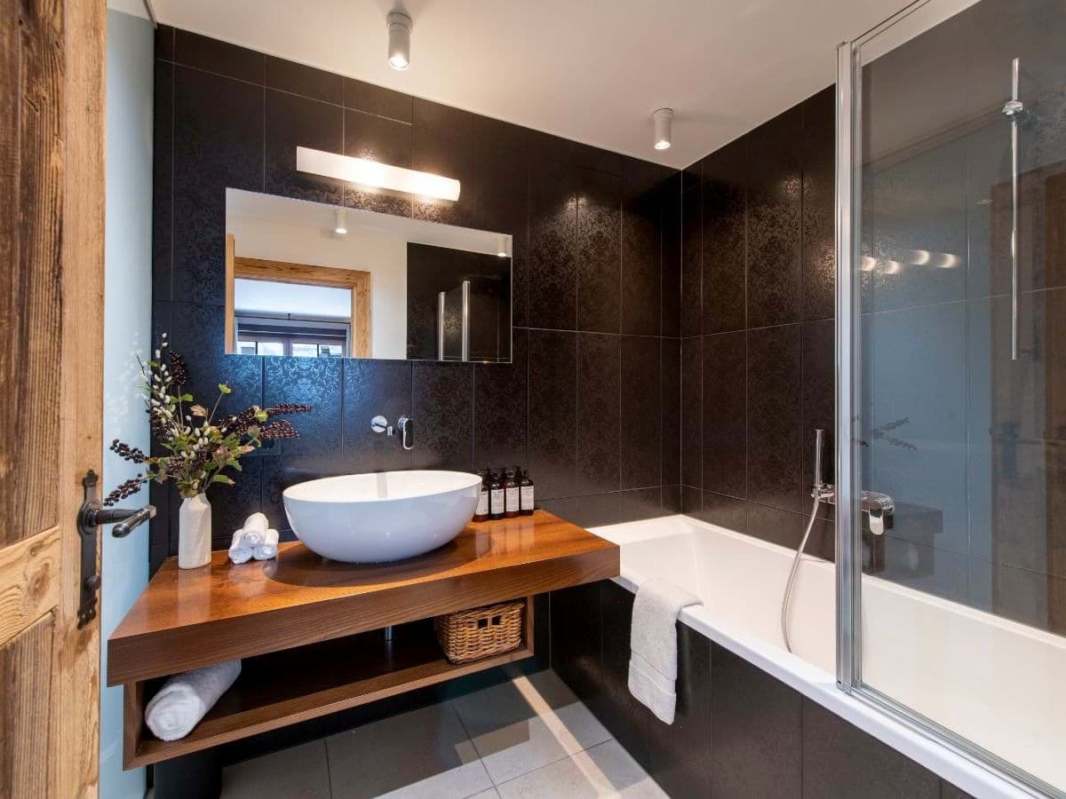 Bathroom with vessel sink and combination soaking tub and shower