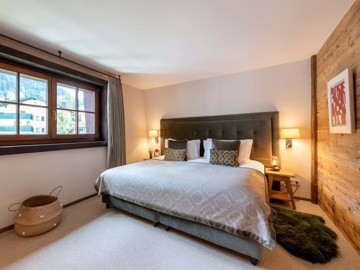Primary bedroom with king bed and reclaimed wood accent wall