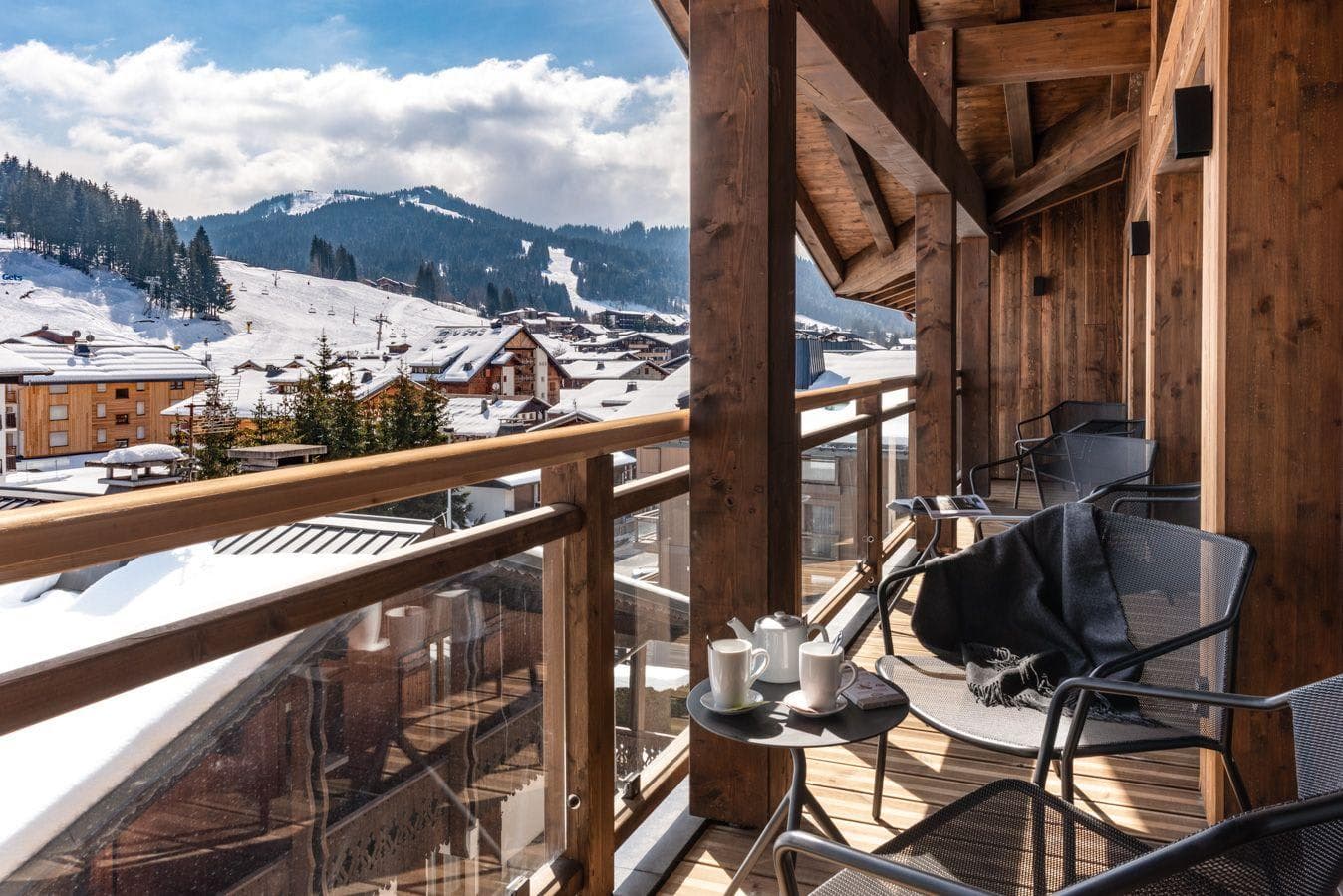 Covered balcony with seating and views of Les Gets ski slopes