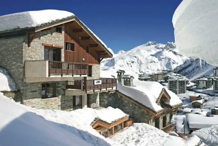 Stone and timber chalet featuring private balconies and mountain views