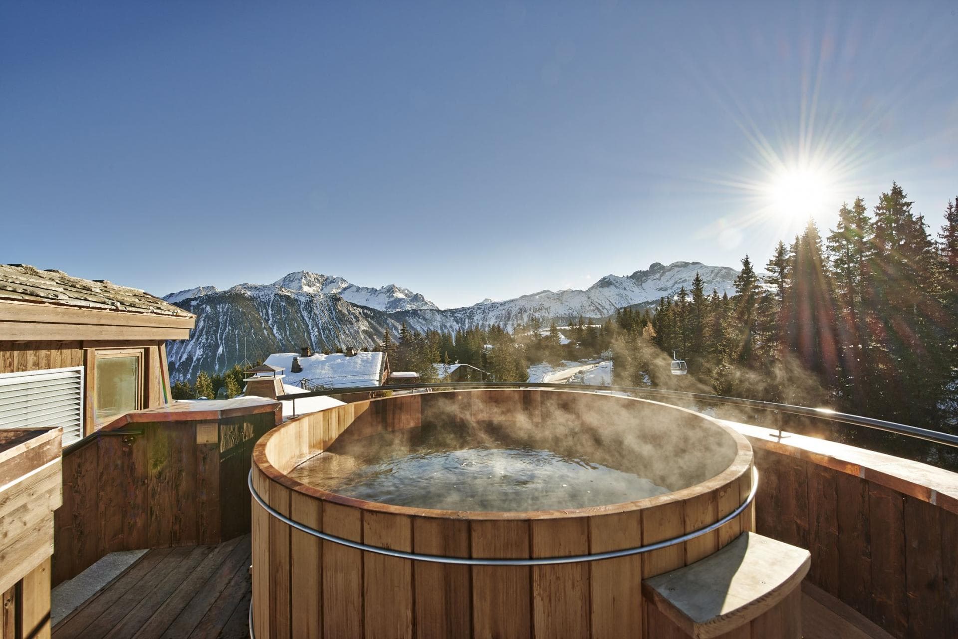 Cedar hot tub on private terrace with mountain and gondola views