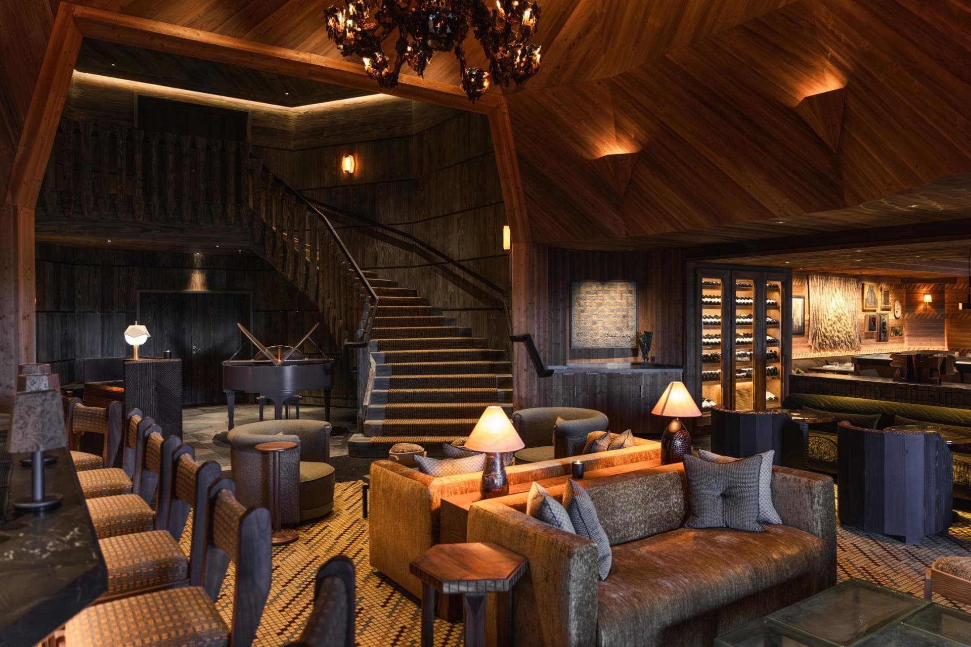Lounge with baby grand piano, bar seating, and temperature-controlled wine storage