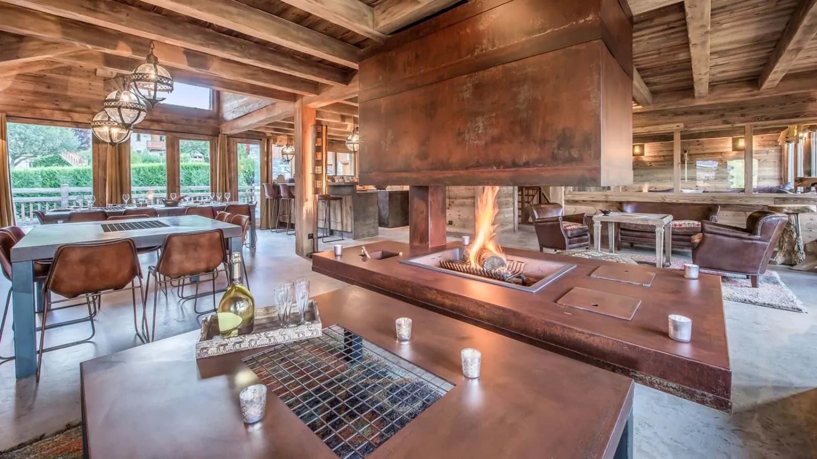 Open-plan living area with 360-degree central steel fireplace