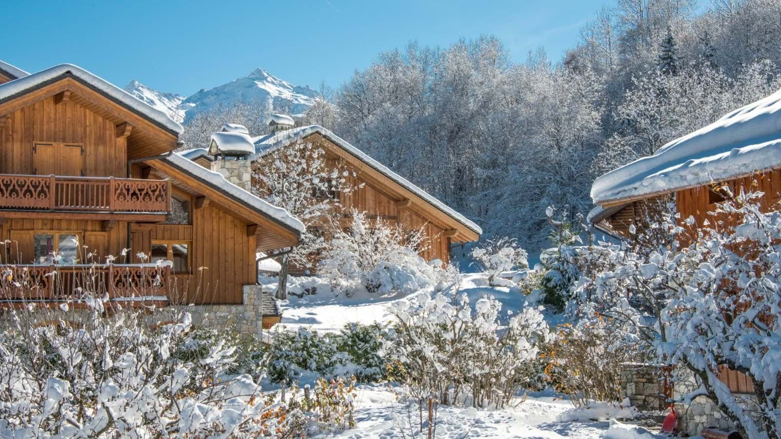 Chalet exterior featuring wood-carved balconies and mountain views