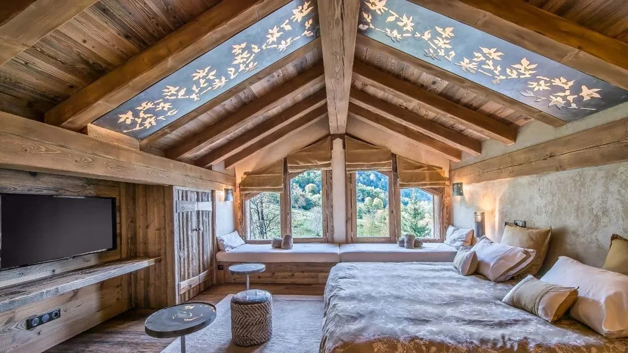Loft bedroom with twin window seats and backlit ceiling art