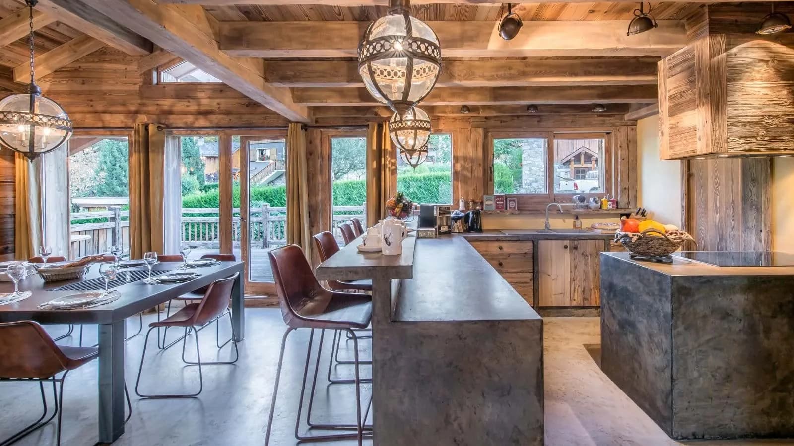 Open kitchen and dining area with concrete counters and balcony access