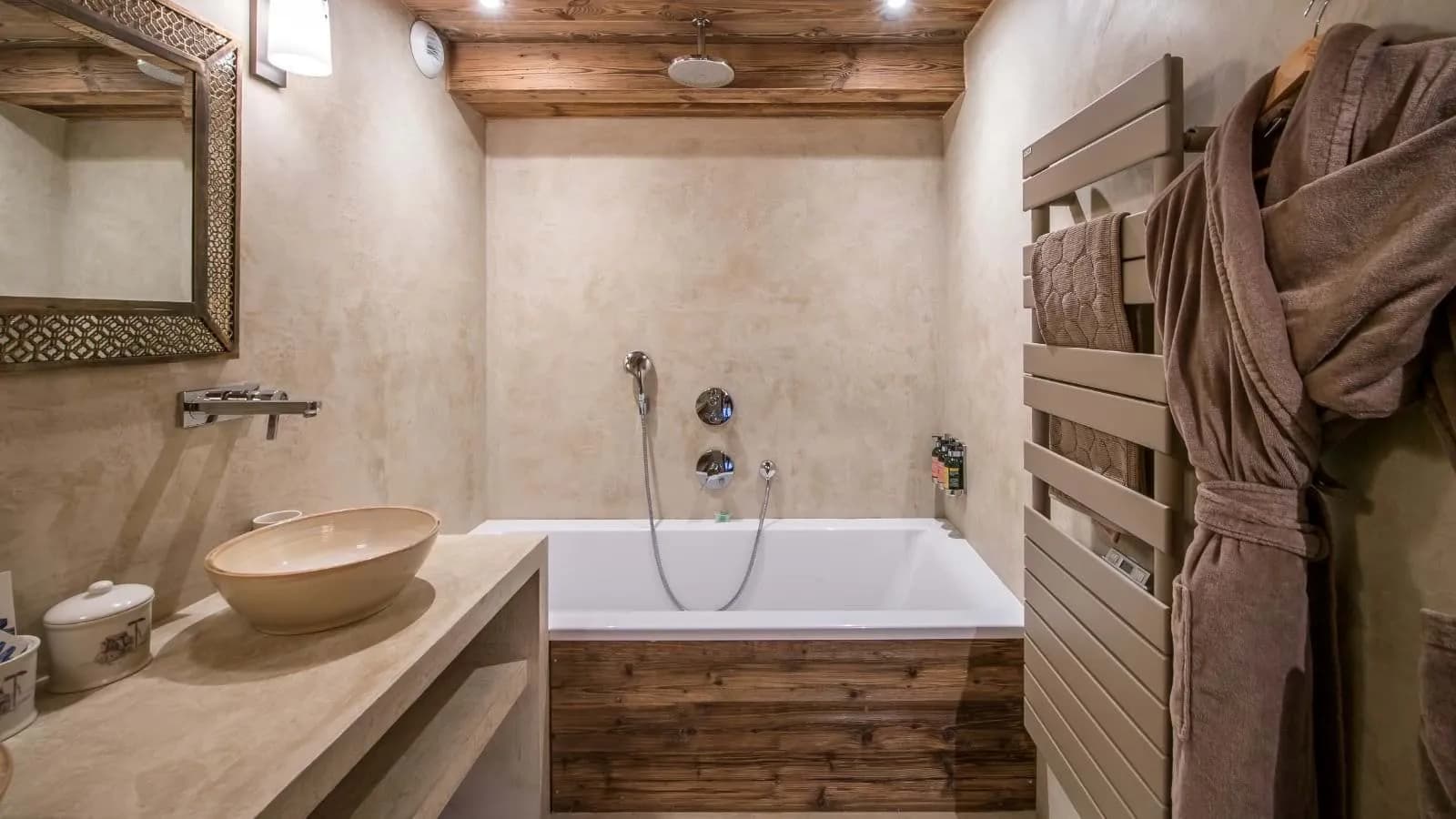 Bathroom with soaking tub, overhead rainfall shower, and heated towel rack