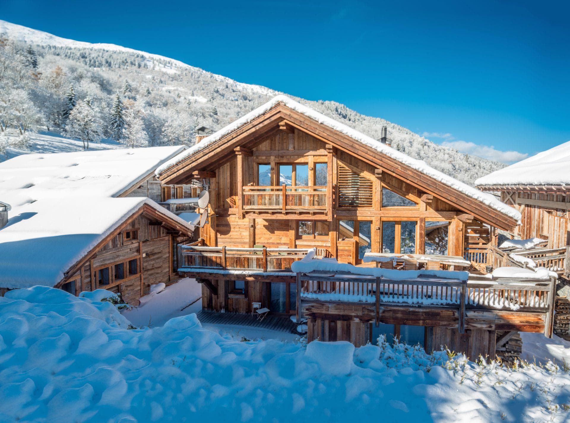 Ski-in chalet with multi-level timber decks and mountain views