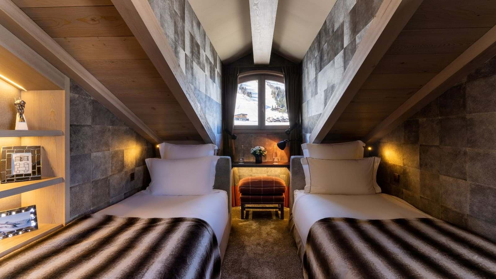 Attic twin bedroom with sloped ceilings and ski slope views