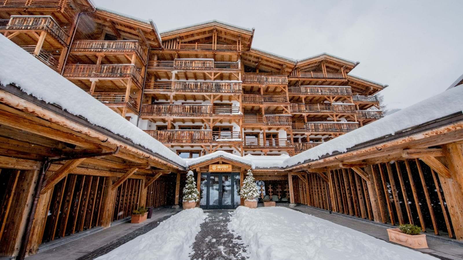 Ski-in entrance with snow-covered walkway and timber balconies