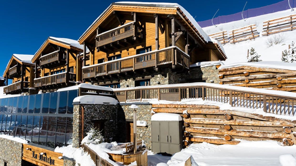 Ski-in/ski-out chalet exterior with private balcony and cedar hot tub