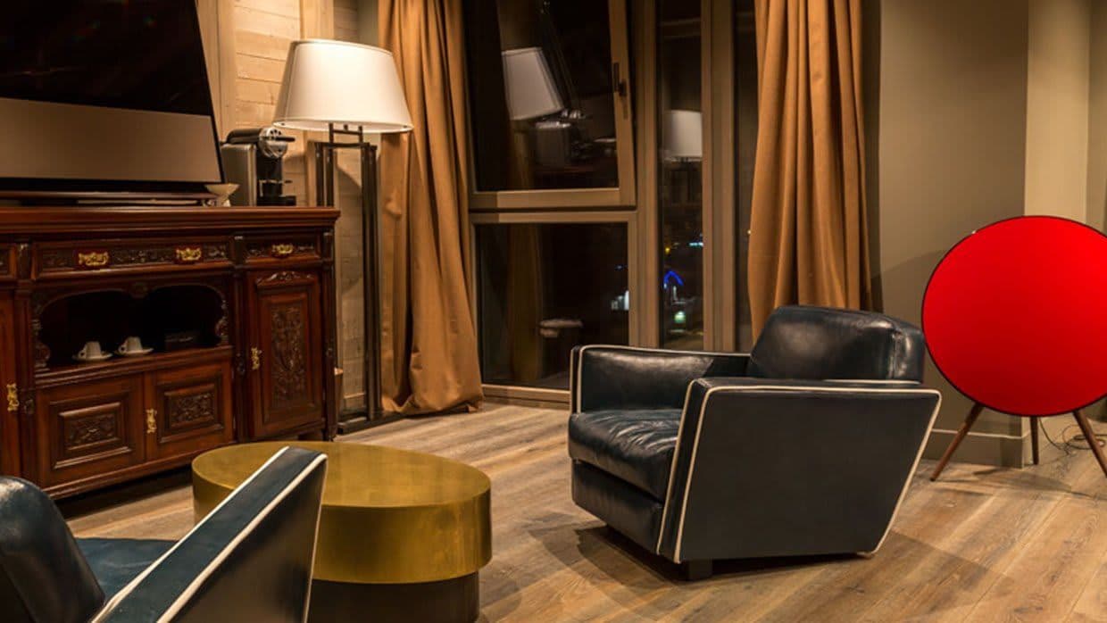 Seating area with leather armchairs, Nespresso machine, and floor-to-ceiling windows