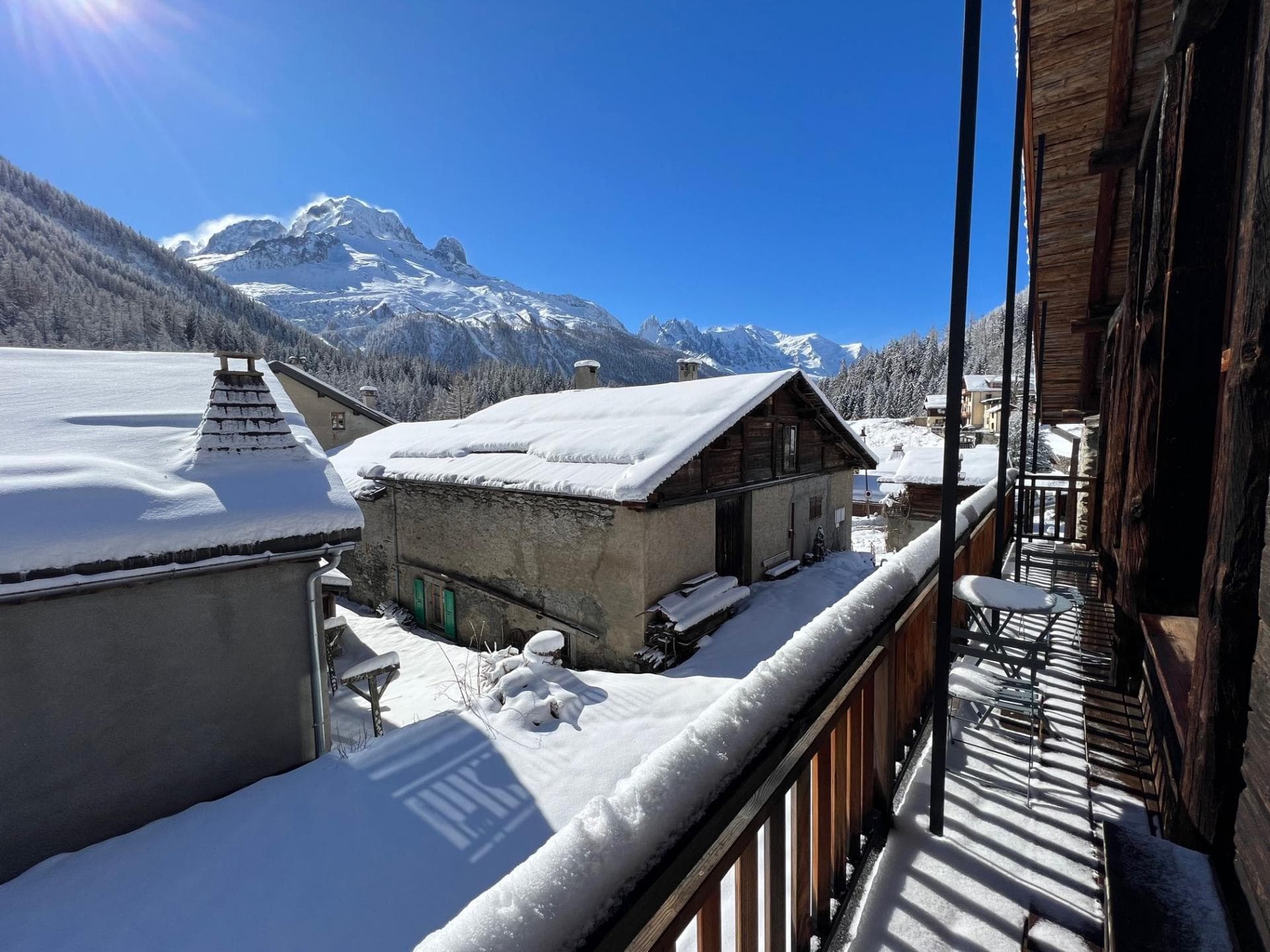 Private balcony with cafe seating and view of snow-capped peaks