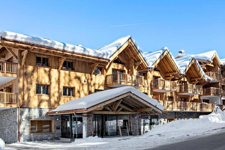 Ski-in, ski-out timber chalet exterior with private balconies and street-level access