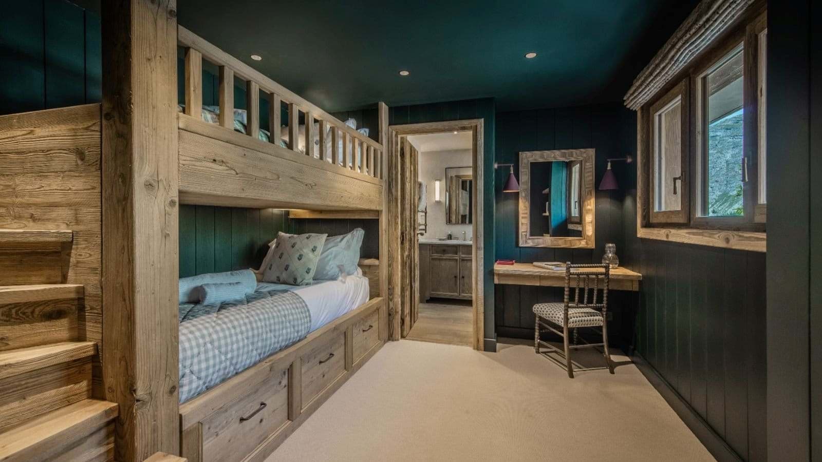 Bunk room with built-in storage and ensuite bathroom access