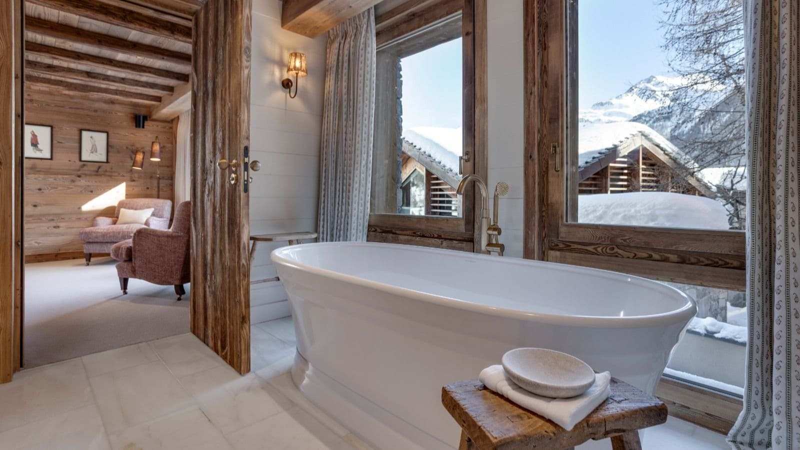 En suite bathroom with freestanding soaking tub and mountain views