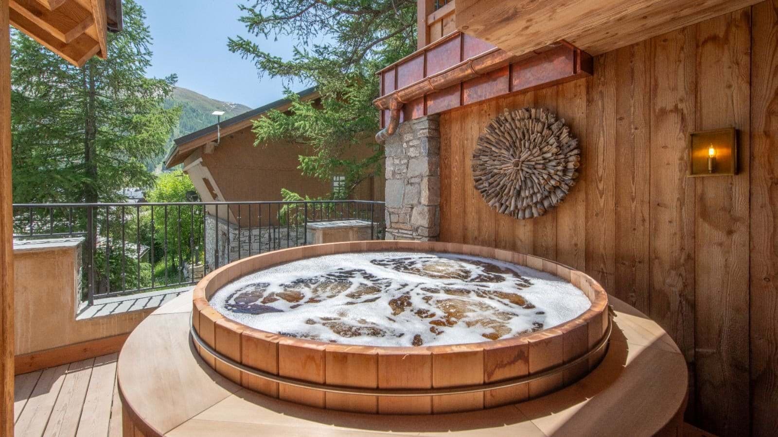 Cedar hot tub on private balcony with valley and mountain views