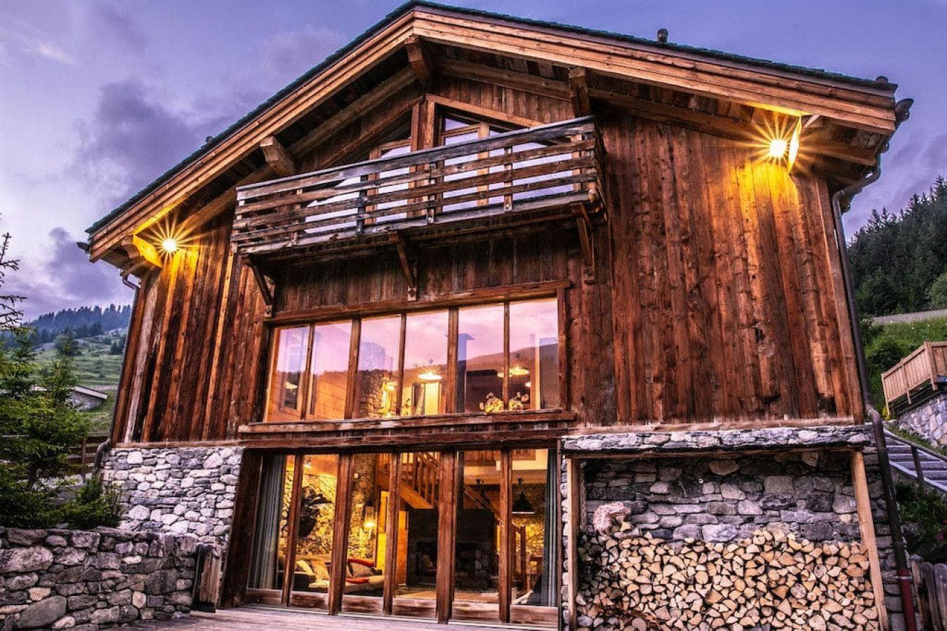 Timber chalet facade with stone foundation and integrated firewood storage