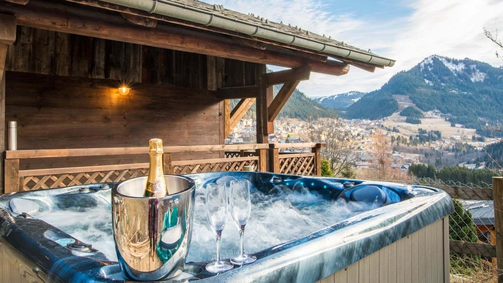Outdoor hot tub with panoramic mountain and village views