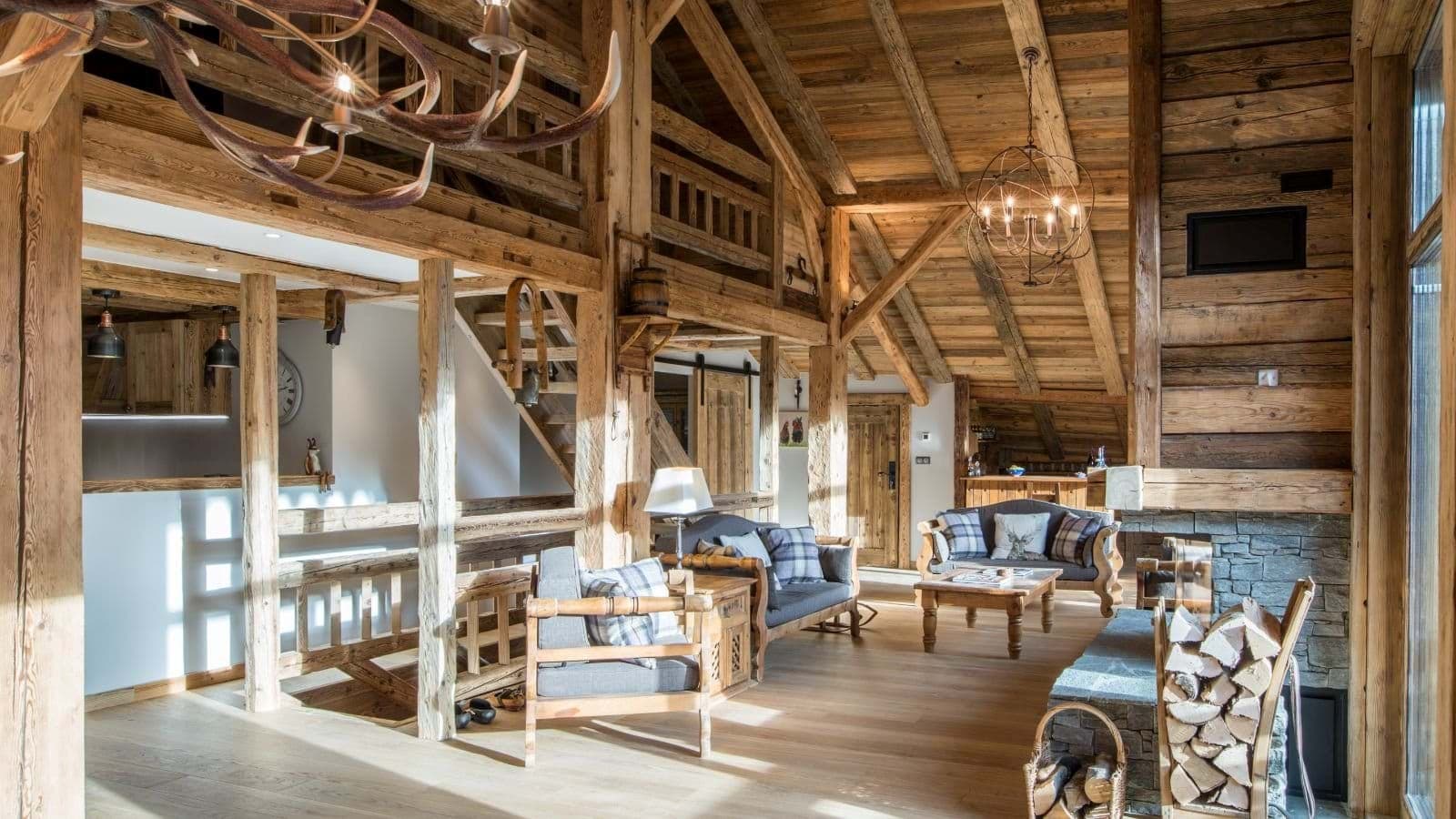 Open living area with stone fireplace and mezzanine level above