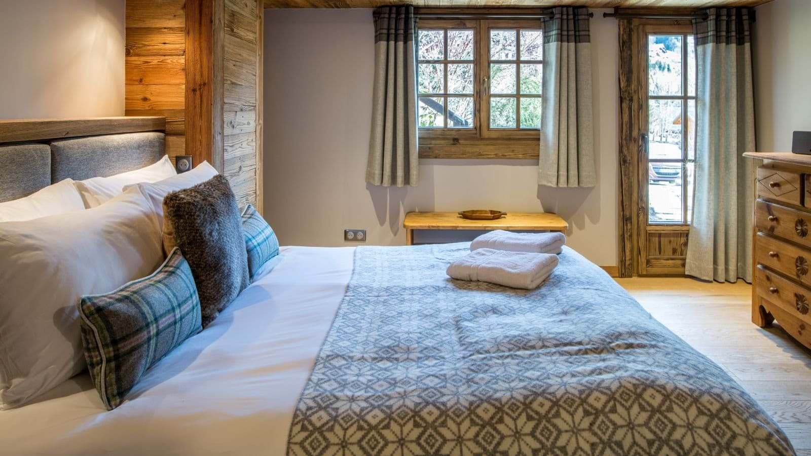 Guest bedroom with king bed and balcony access