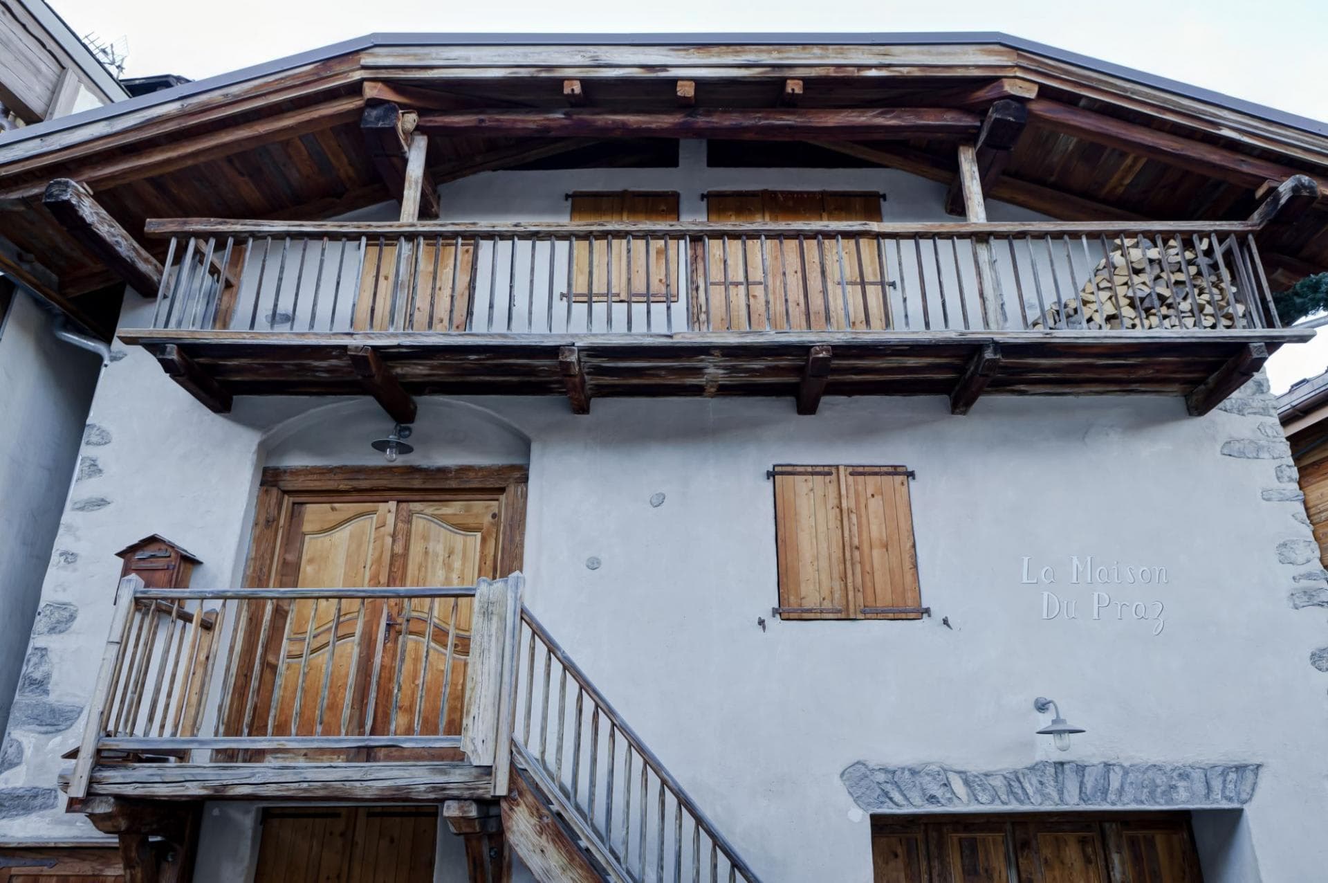 Chalet entrance featuring original timber balconies and traditional stone masonry