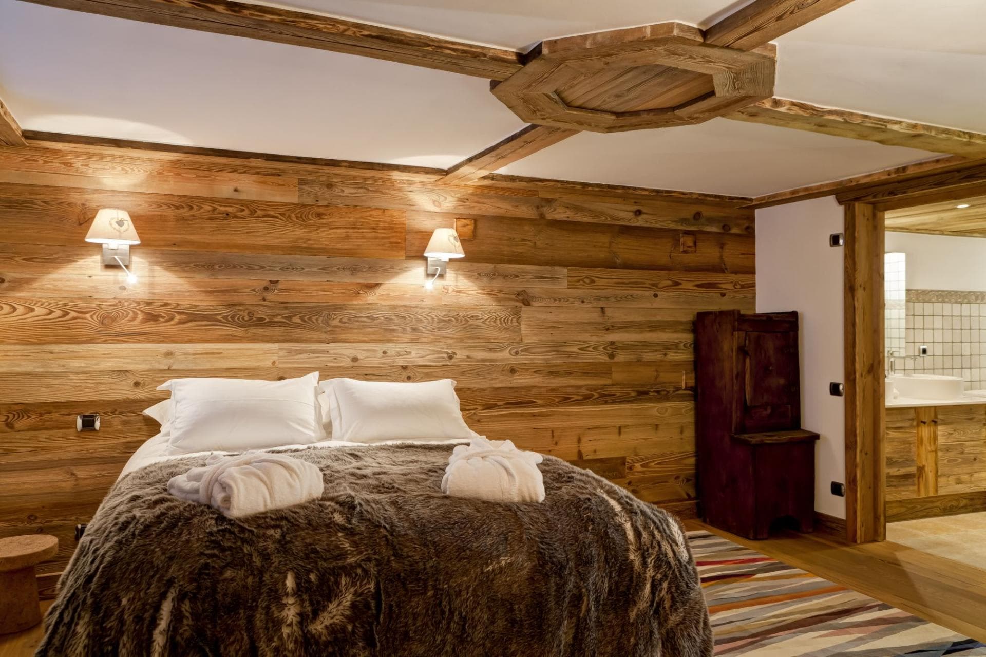 Bedroom with reclaimed wood walls and en-suite bathroom access