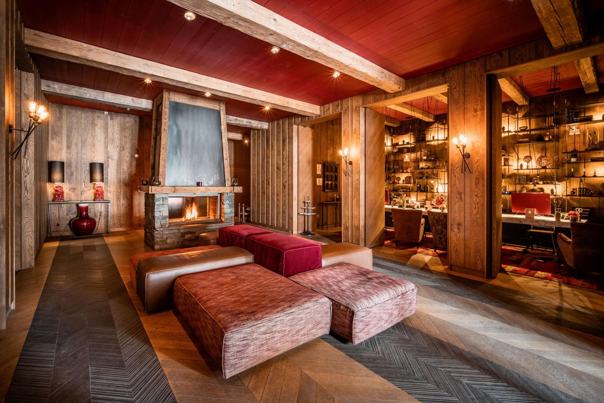 Lounge with wood-burning fireplace and adjacent library workspace