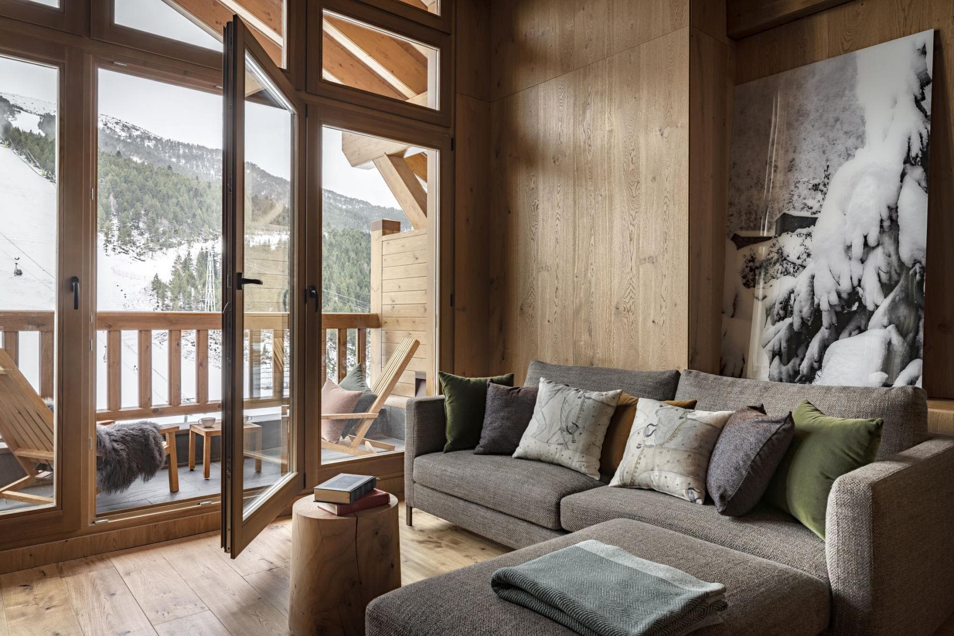 Living area with sofa seating and balcony access to mountain views