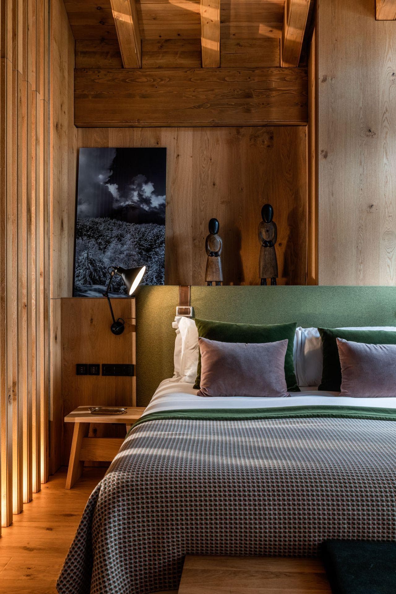 Bedroom with adjustable reading light and integrated bedside power outlets