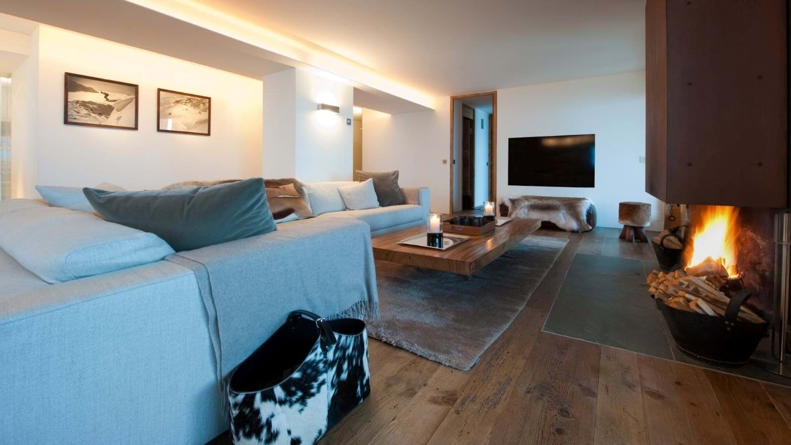 Living area with wood-burning fireplace and sectional sofa seating