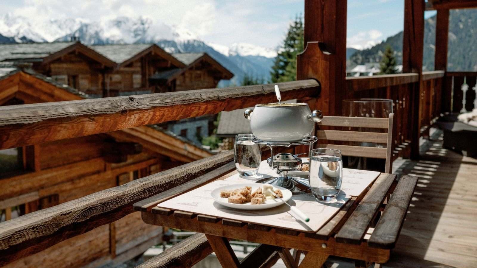 Private balcony with fondue set and panoramic Alps views