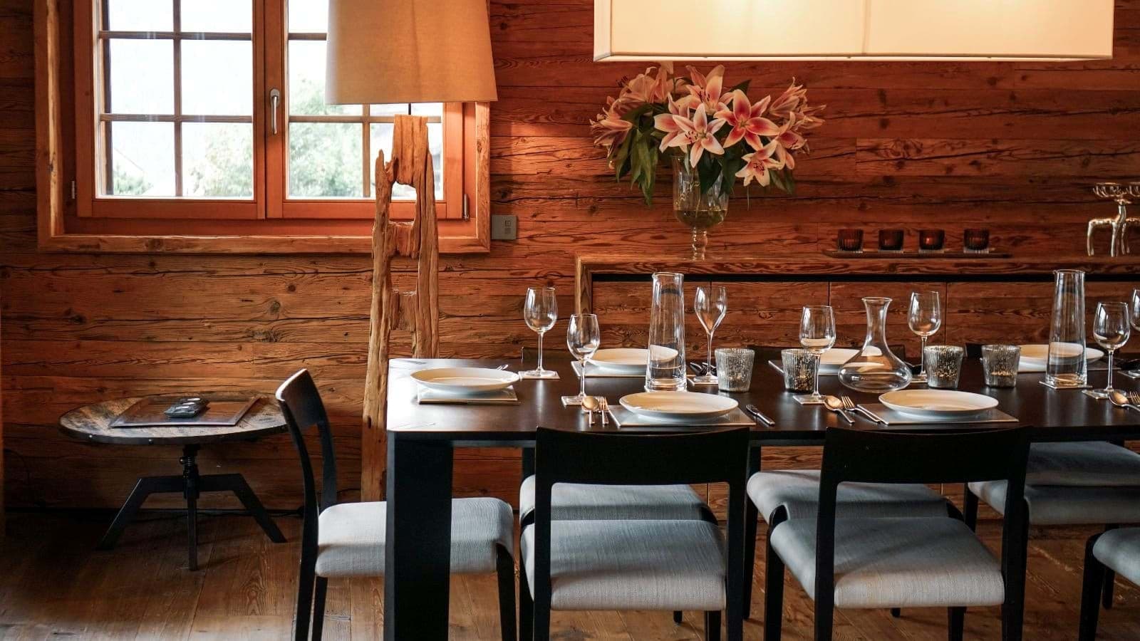 Dining area with seating for 8; reclaimed wood paneled walls