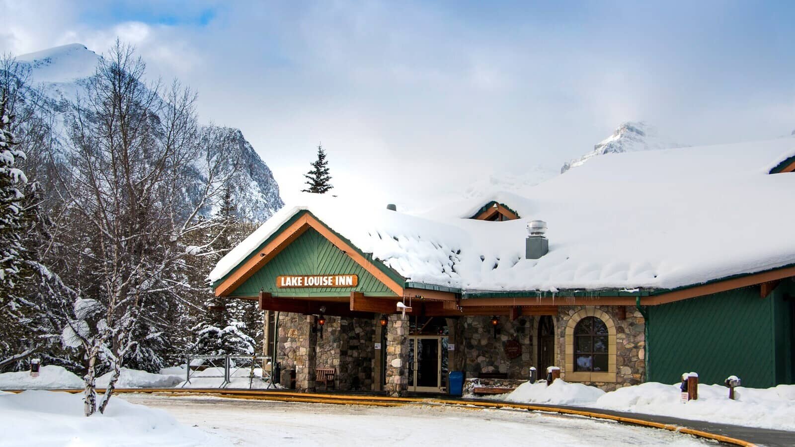 Lake Louise Inn entrance and porte-cochère with mountain views
