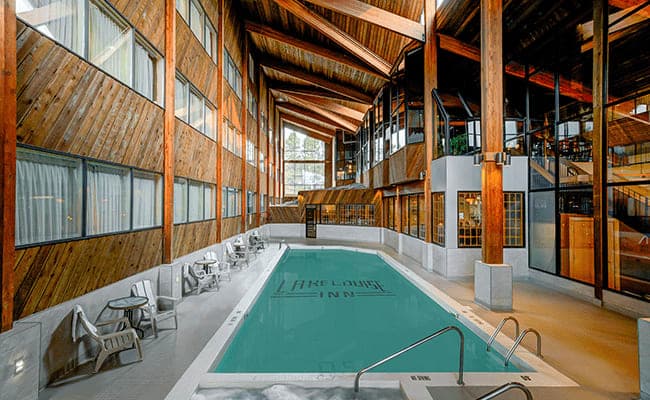 Indoor heated pool with cedar-vaulted ceilings and adjacent hot tub