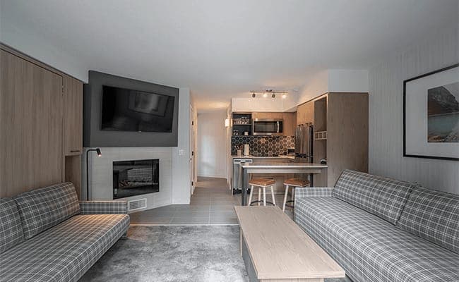 Open living area with gas fireplace and breakfast bar seating for two