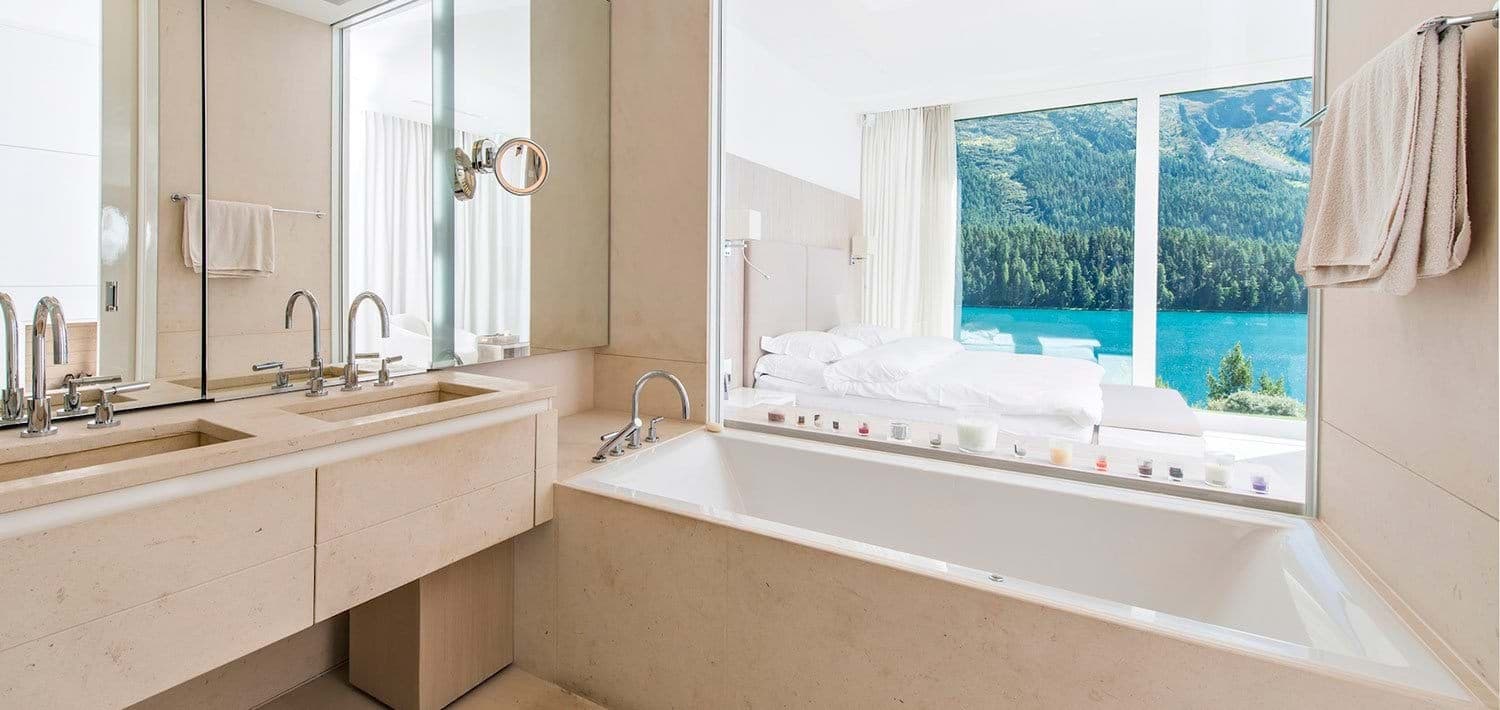 Bathroom with dual vanity and soaking tub overlooking lake views