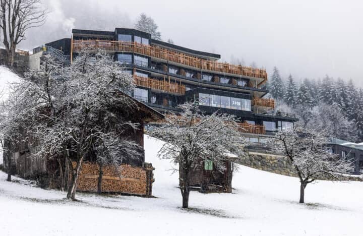 Ski-in ski-out access via mountain-facing balconies and terraced timber decks