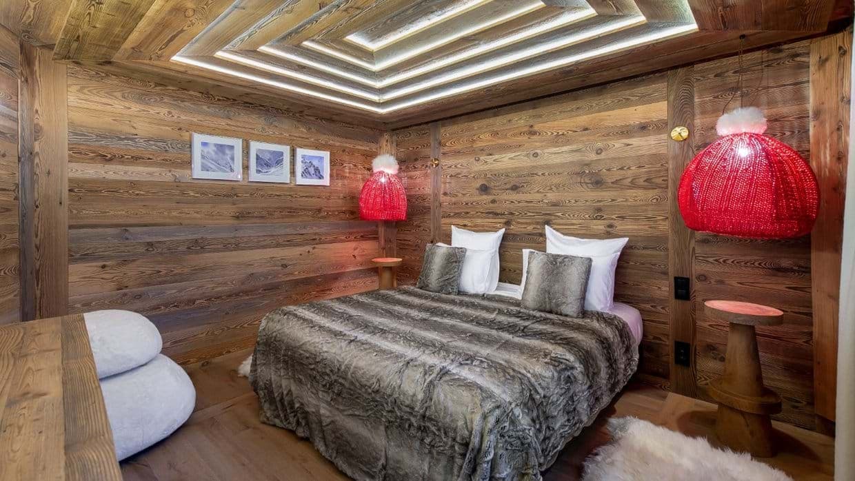 Bedroom with wood-paneled walls and recessed LED ceiling lighting