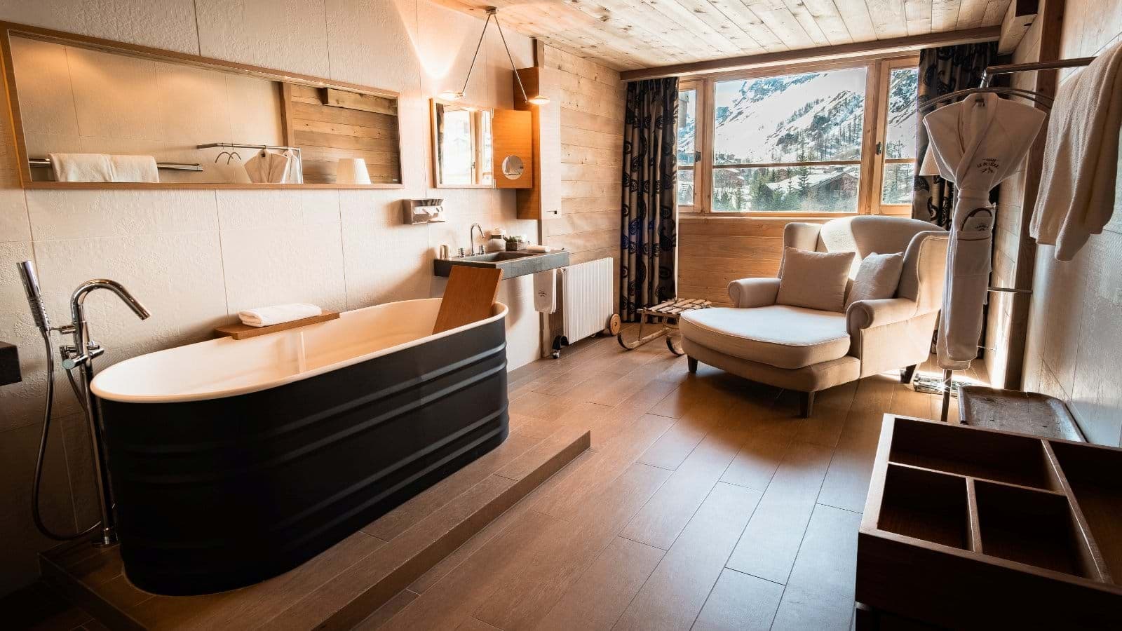 En suite bathroom with freestanding soaking tub and mountain views